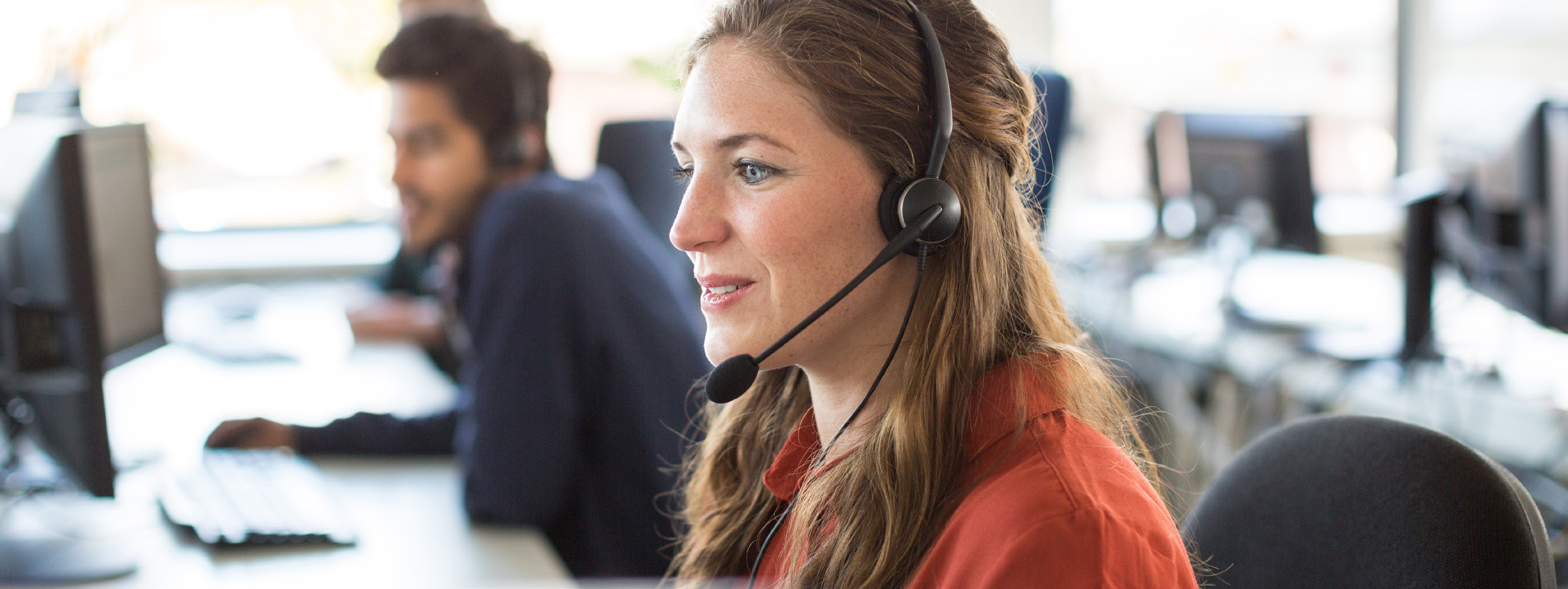 Customer service agent taking a call on a headset